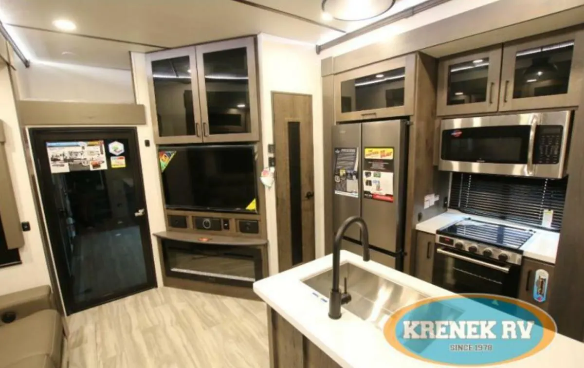 Kitchen with a gas burner, fridge, oven, sink and cabinets.