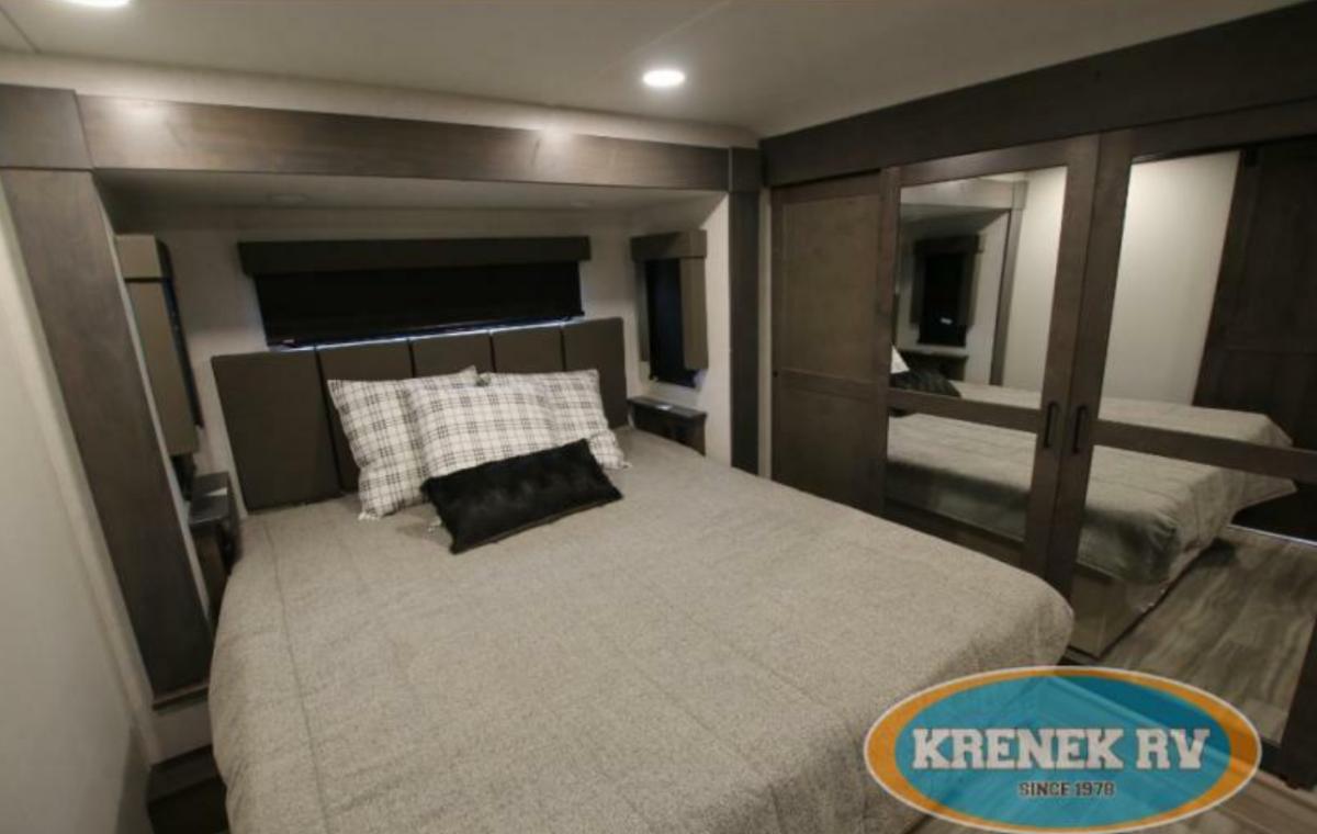 Bedroom with a queen size bed and a closet.