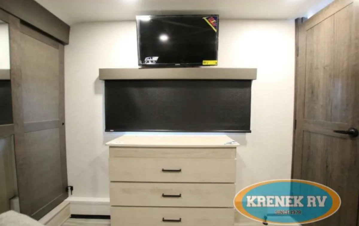 Bedroom with a dresser and a TV.