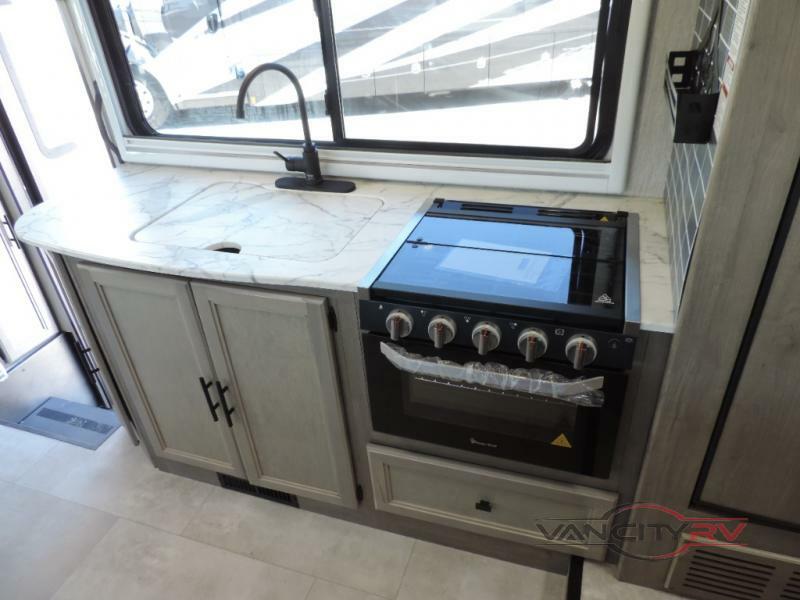 Kitchen with a gas burner, sink and cabinets.