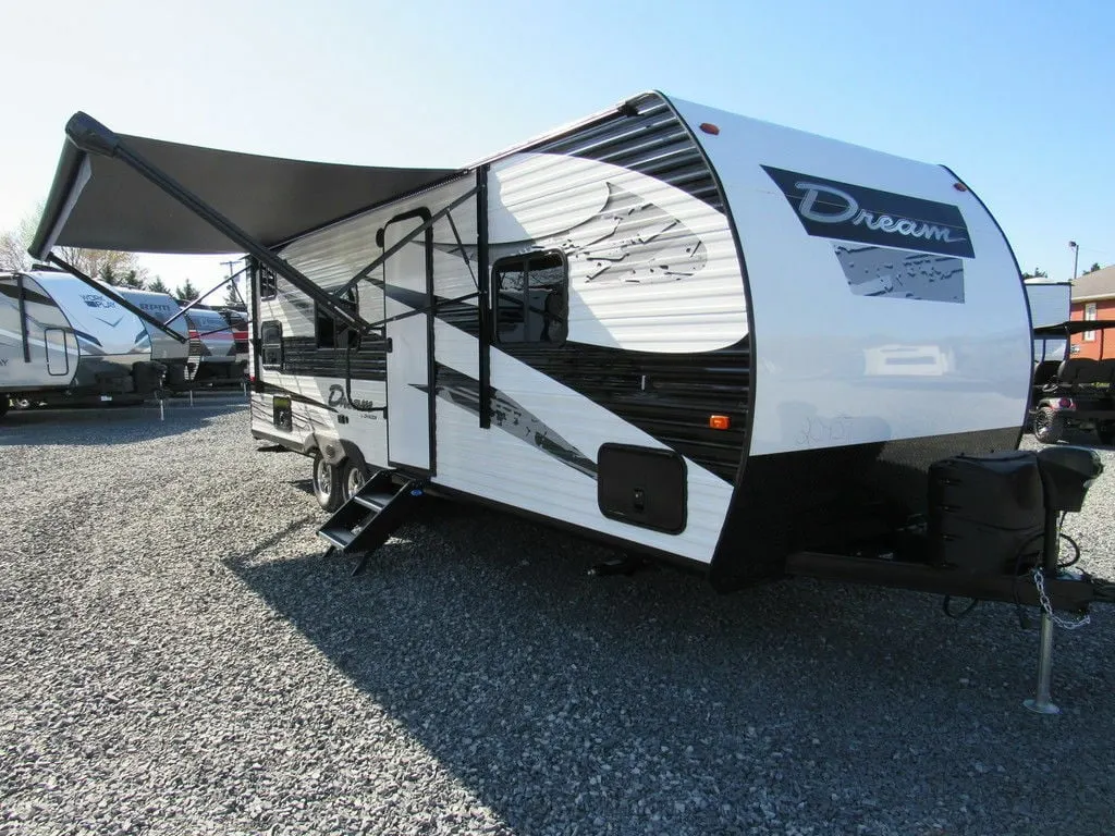 Side view of the RV with an awning.