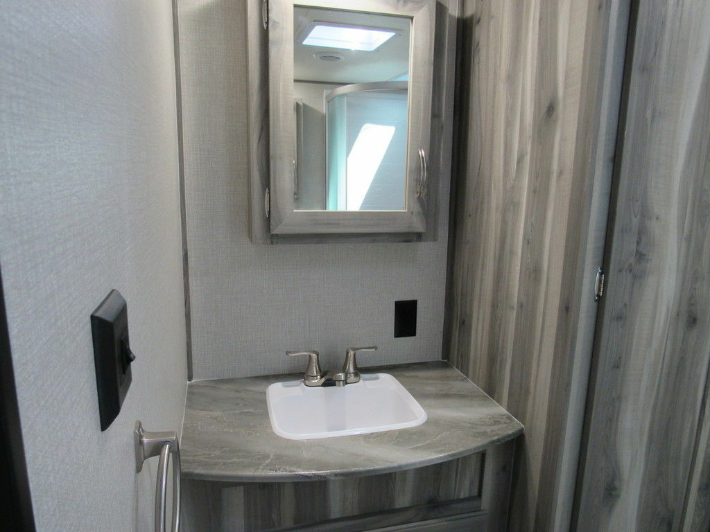 Bathroom sink with a medicine cabinet.