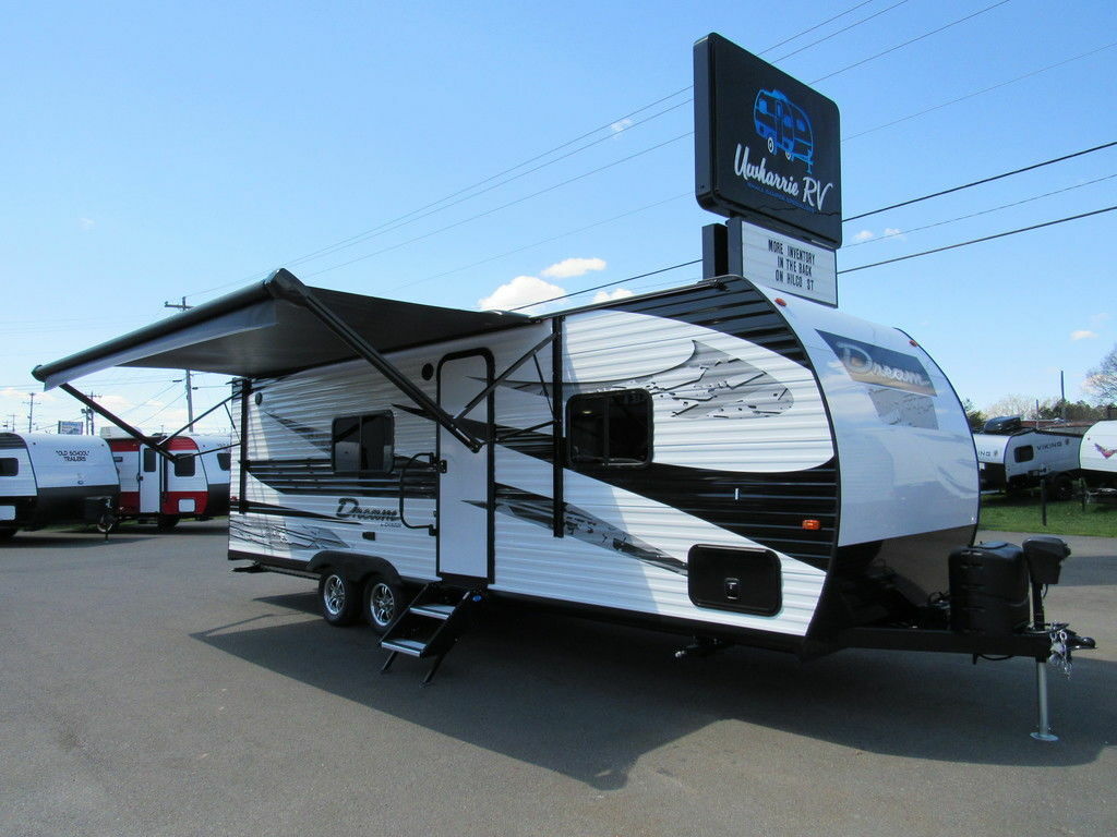 Side view of the RV with an awning.