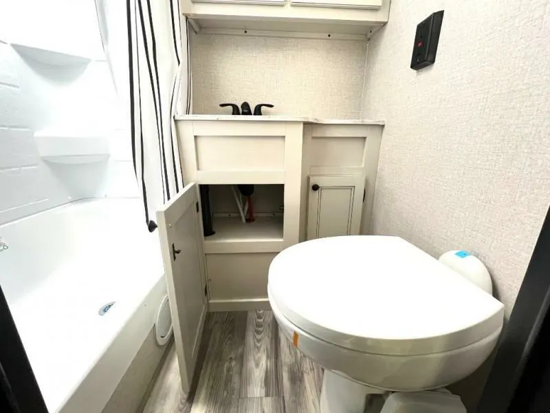 Bathroom with a sink, toilet and a shower.