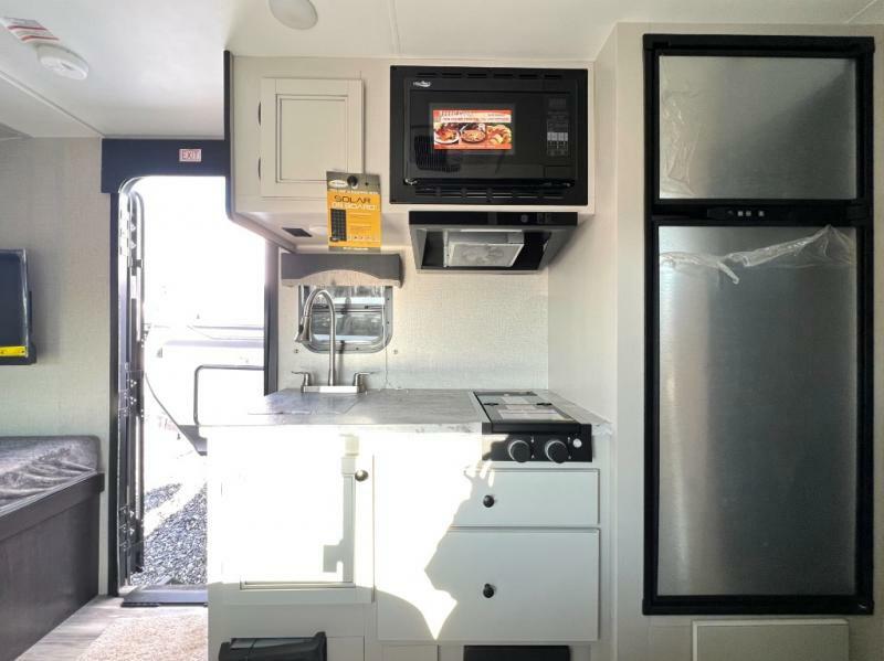 Kitchen with a gas burner, fridge, oven, sink and cabinets.