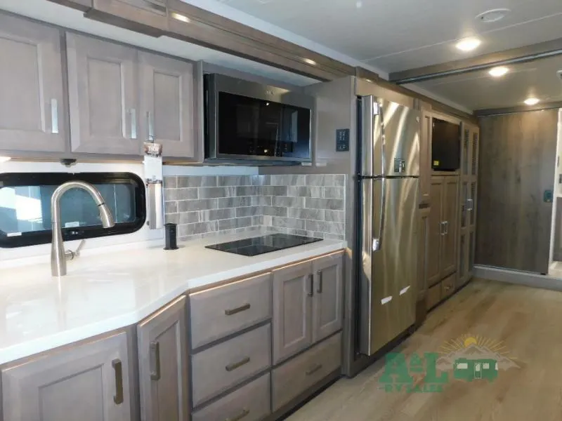 Kitchen with a gas burner, fridge, oven, sink and cabinets.