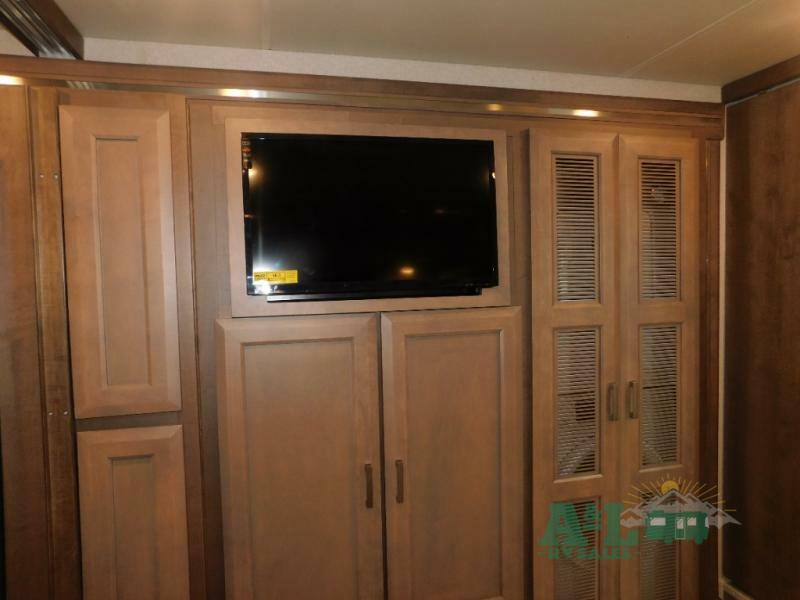 Bedroom with with a wall-mounted TV and a closet.