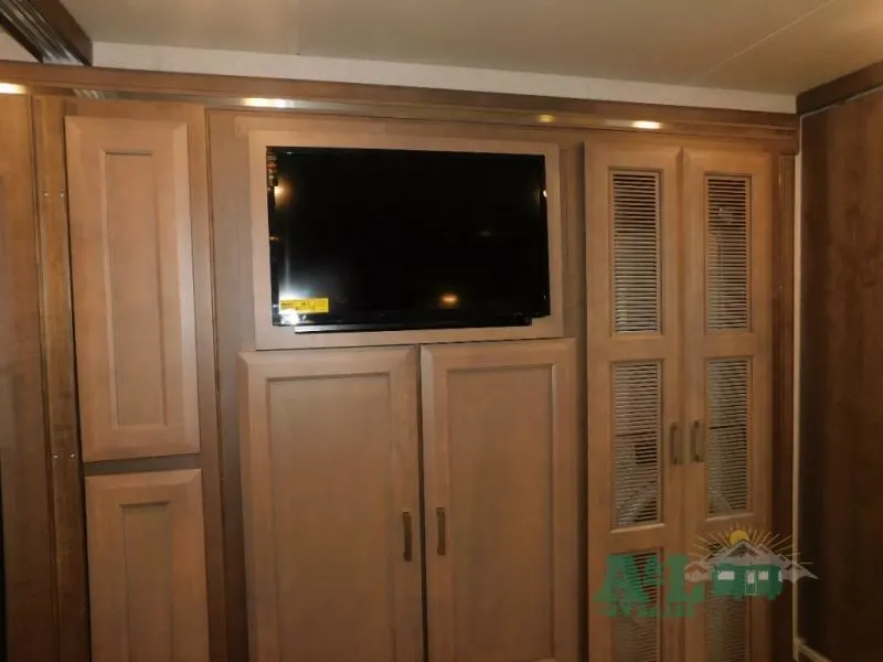 Bedroom with with a wall-mounted TV and a closet.