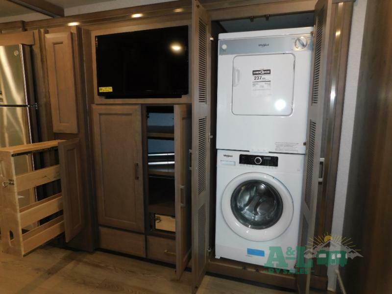 Bedroom with with a wall-mounted TV, a closet and laundry area.