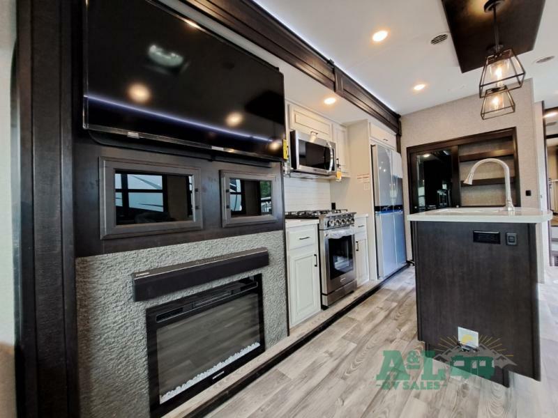 Entertainment center with a TV and a fireplace.