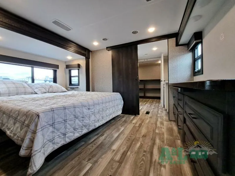 Bedroom with a queen size bed and a walk-in closet.