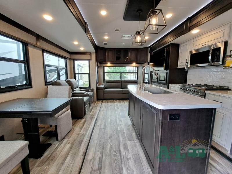 Interior view of the RV with a dinette, living space and a kitchen.