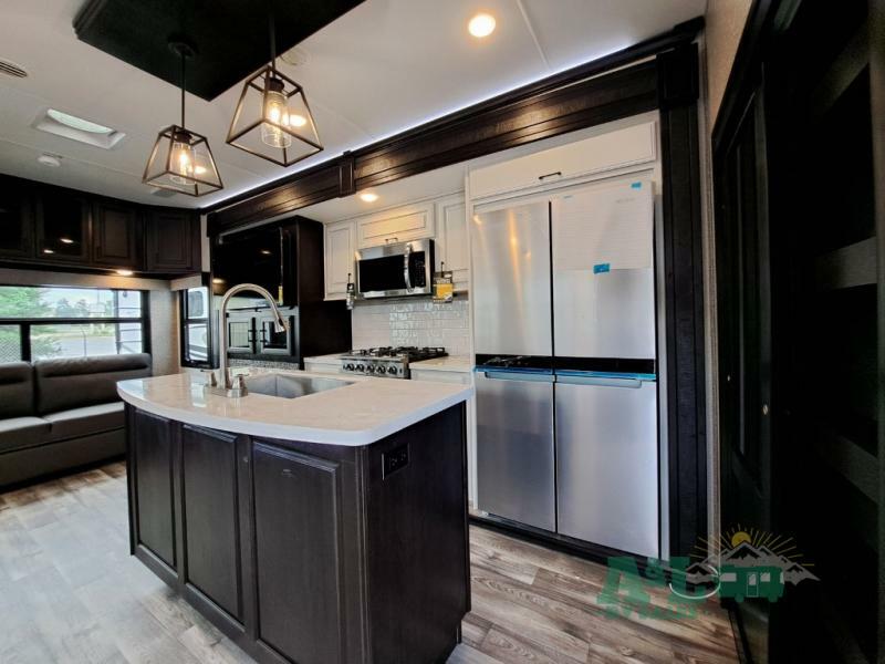 Kitchen with a gas burner, fridge, oven, sink and cabinets.