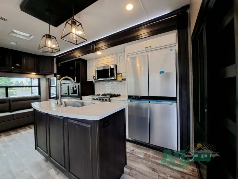 Kitchen with a gas burner, fridge, oven, sink and cabinets.