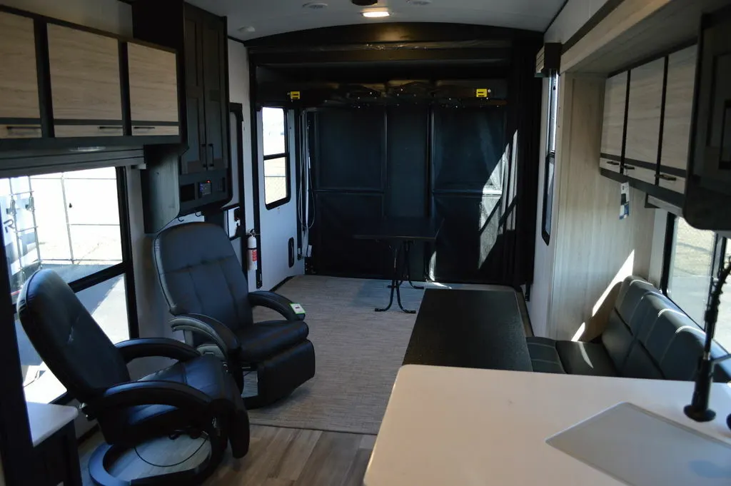 Interior view of the RV with a dinette and living space.