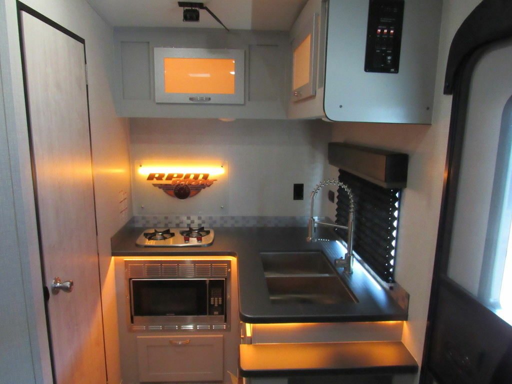 Kitchen with a gas burner, oven, sink and cabinets.