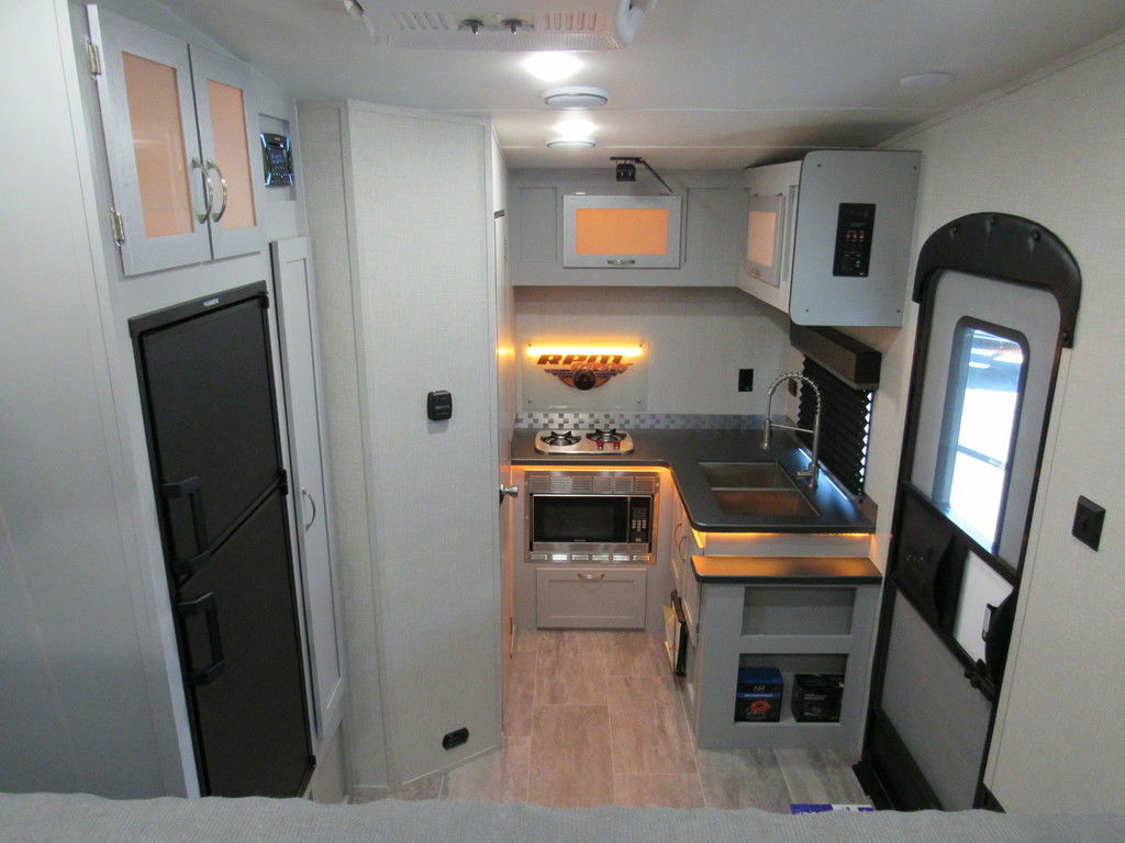 Kitchen with a gas burner, oven, sink and cabinets.