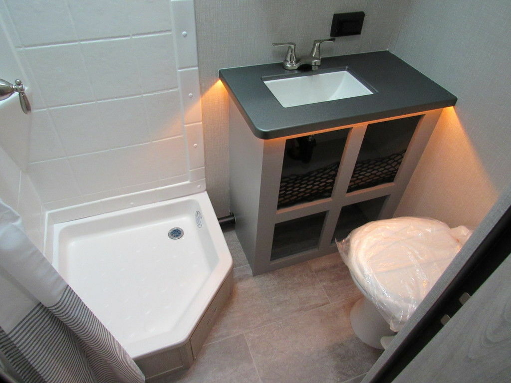 Bathroom with a sink, toilet and a shower.