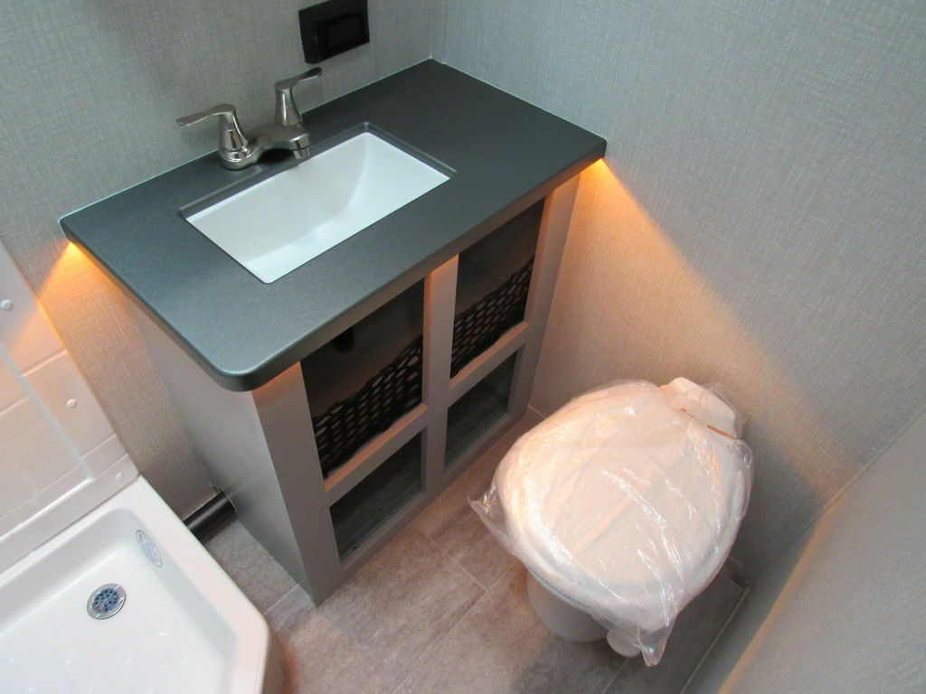 Bathroom with a sink, toilet and a shower.