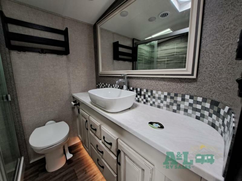 Bathroom with a sink, toilet and a walk-in shower.