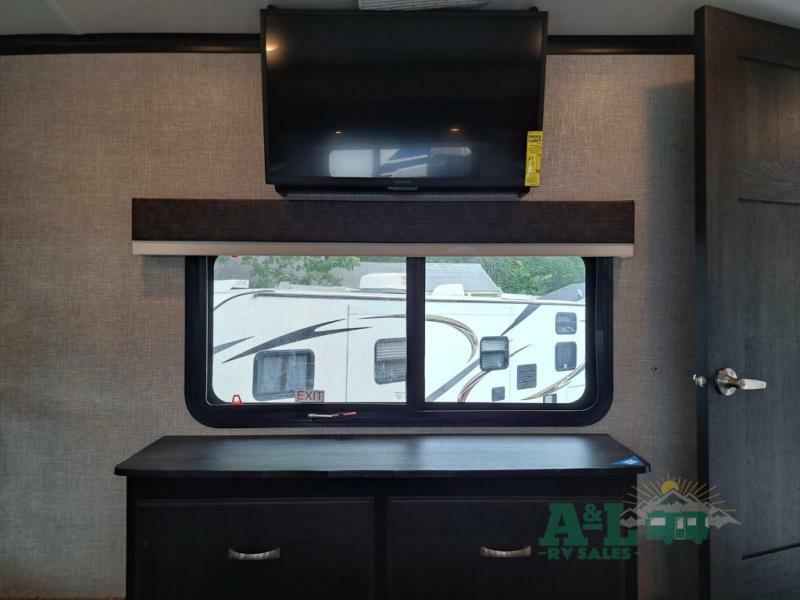 Bedroom with a dresser and a TV.