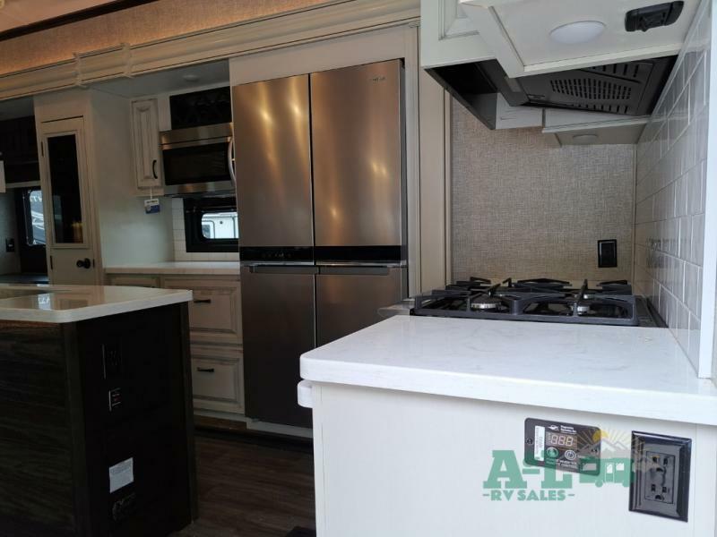 Kitchen with a gas burner, fridge, oven, sink and cabinets.