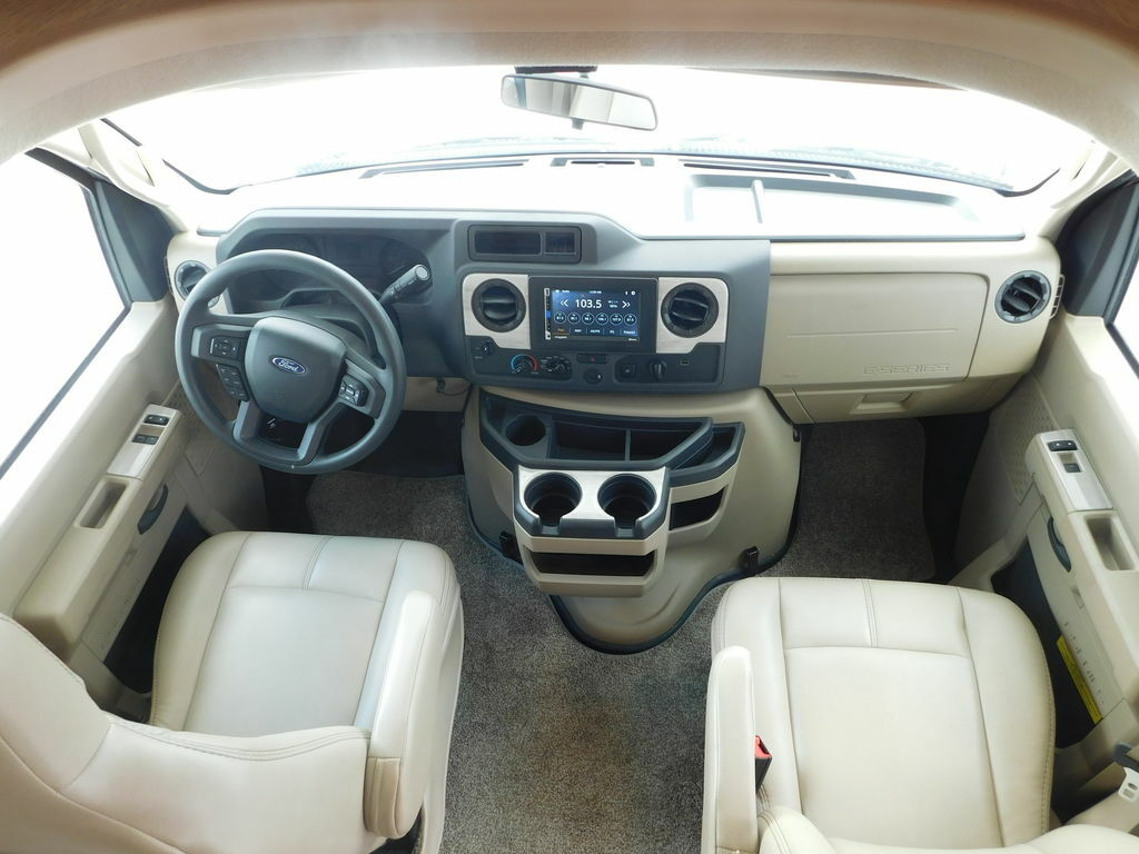 Interior of the RV with a steering wheel and dashboard.