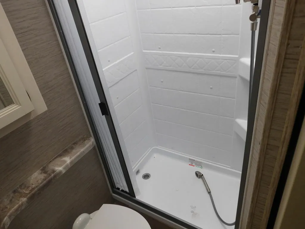 Bathroom with a toilet and a walk-in shower.