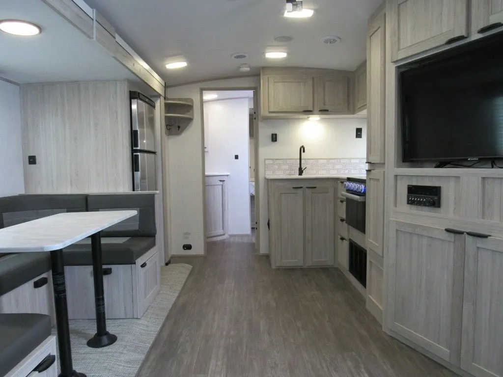 Interior view of the RV with a dinette and a kitchen.