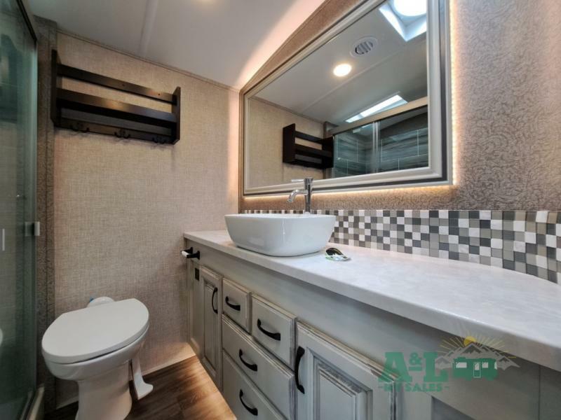 Bathroom with a sink, toilet and a walk-in shower.