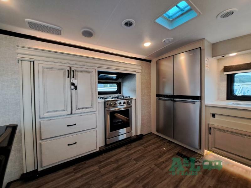 Kitchen with a gas burner, fridge, and cabinets.