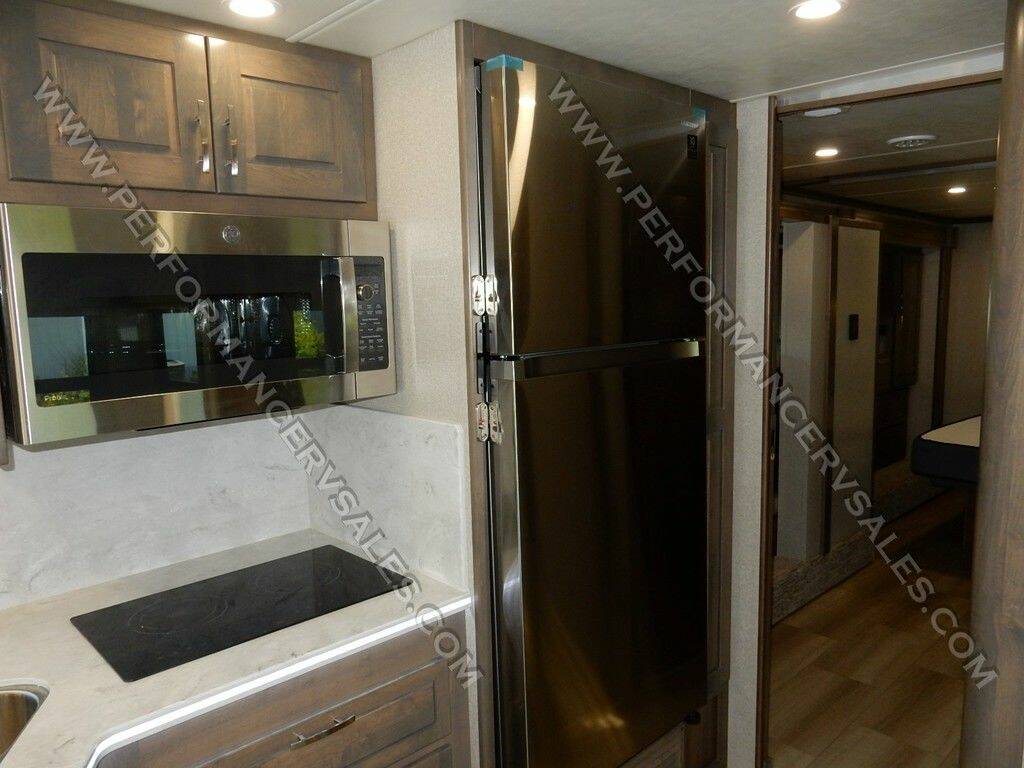 Kitchen with a fridge, oven, and cabinets.