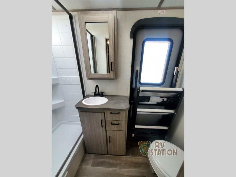 Bathroom with a sink, toilet and a walk-in shower.