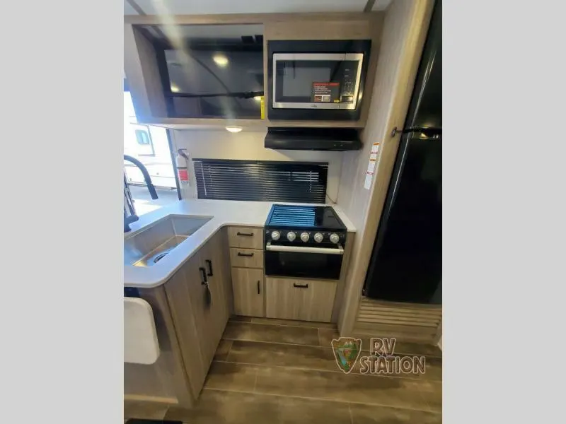 Kitchen with a gas burner, fridge, oven, sink and cabinets.