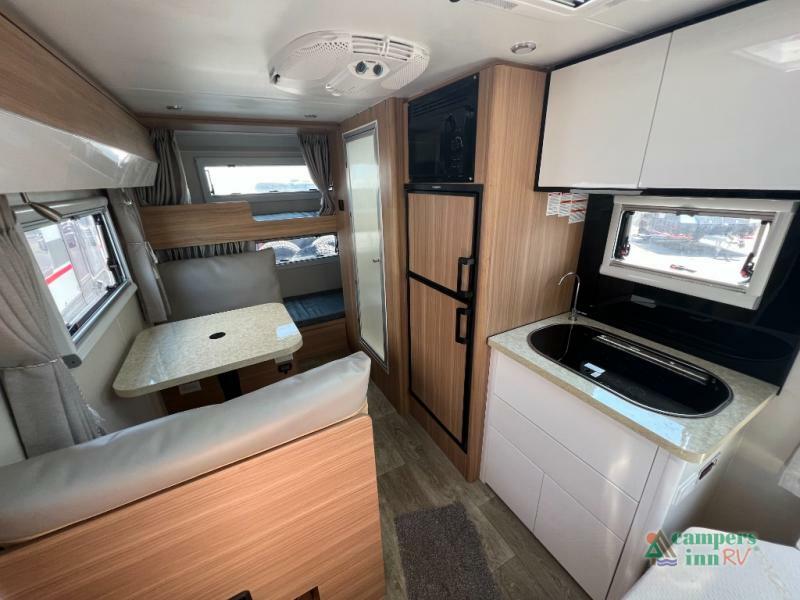 Interior view of the RV with a dinette and a kitchen.