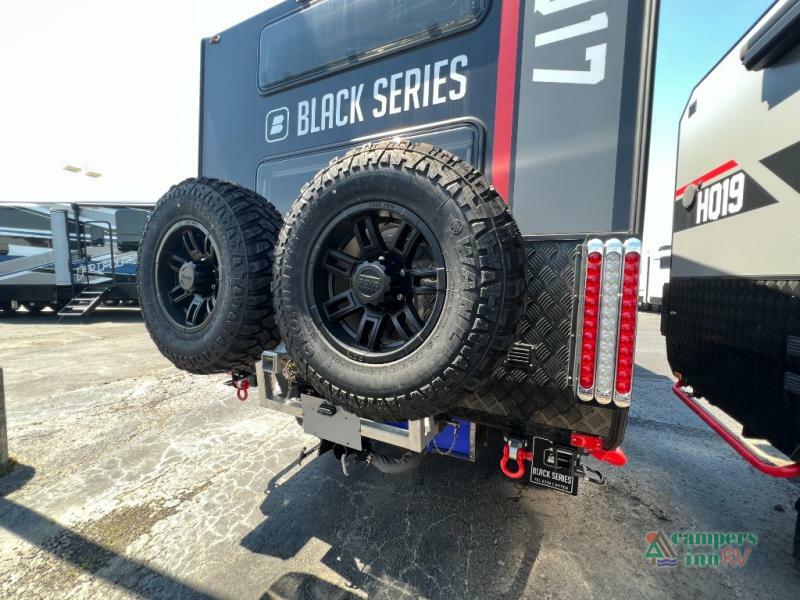 Rear view of the RV with spare tires