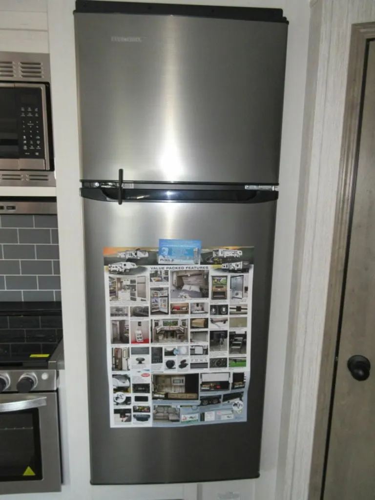 Kitchen with a gas burner, fridge, and oven.