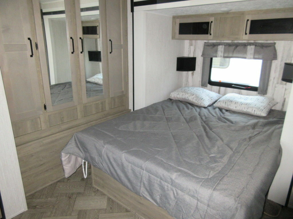 Bedroom with a queen size bed and a closet.