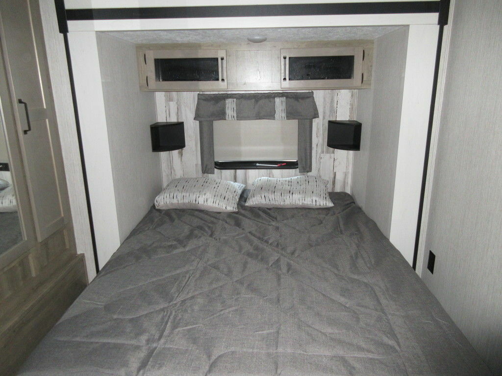 Bedroom with overhead cabinets.