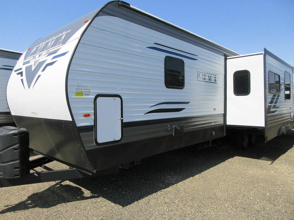 Side view of the New 2022 Palomino Puma 32BHQS Travel Trailer RV.