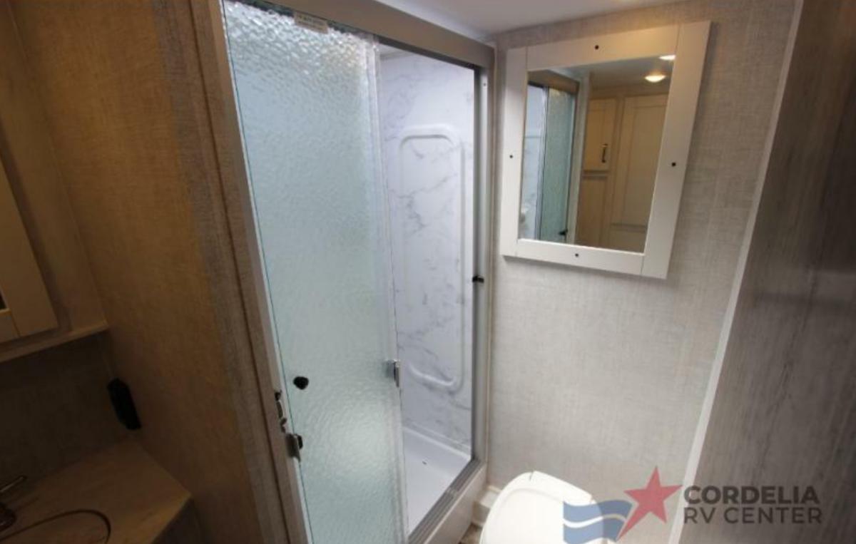 Bathroom with a toilet and a walk-in shower.