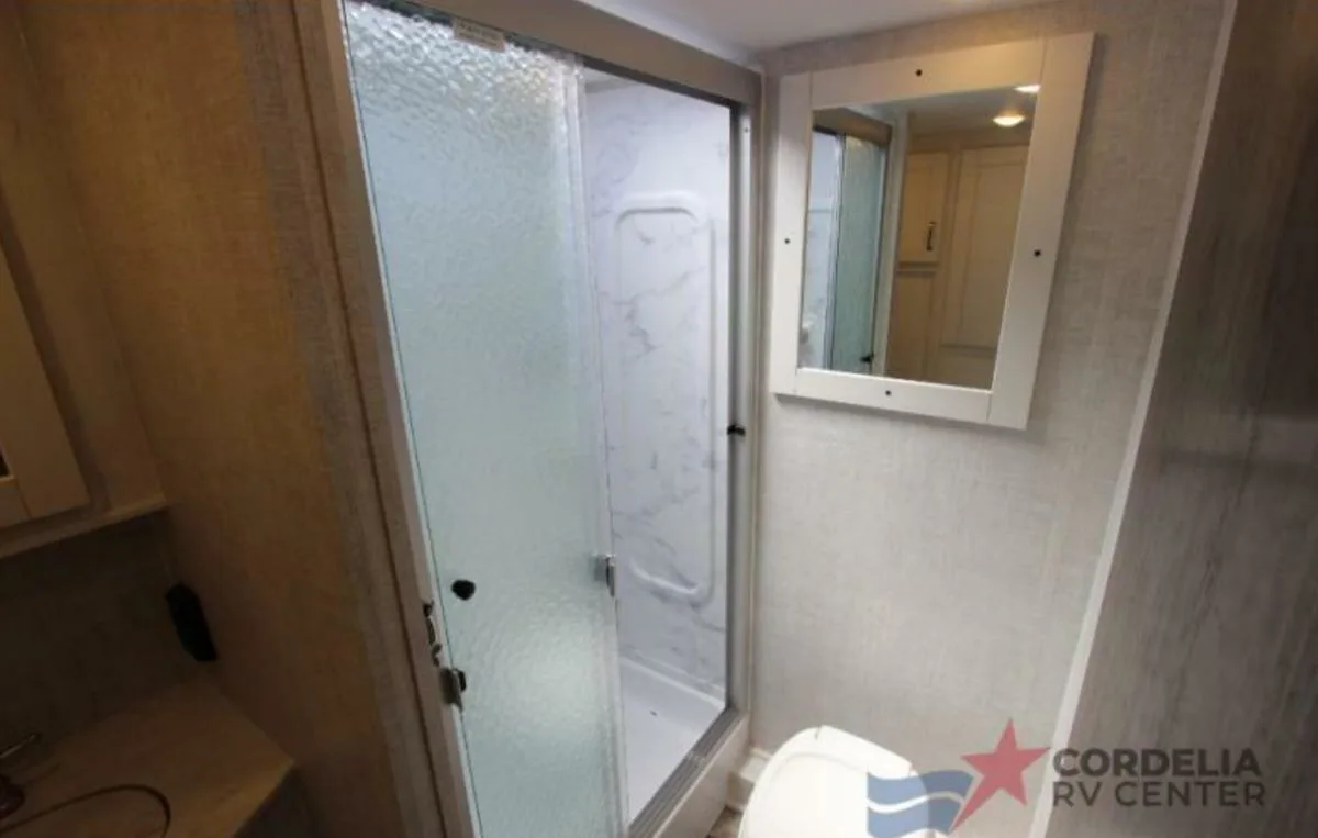 Bathroom with a toilet and a walk-in shower.