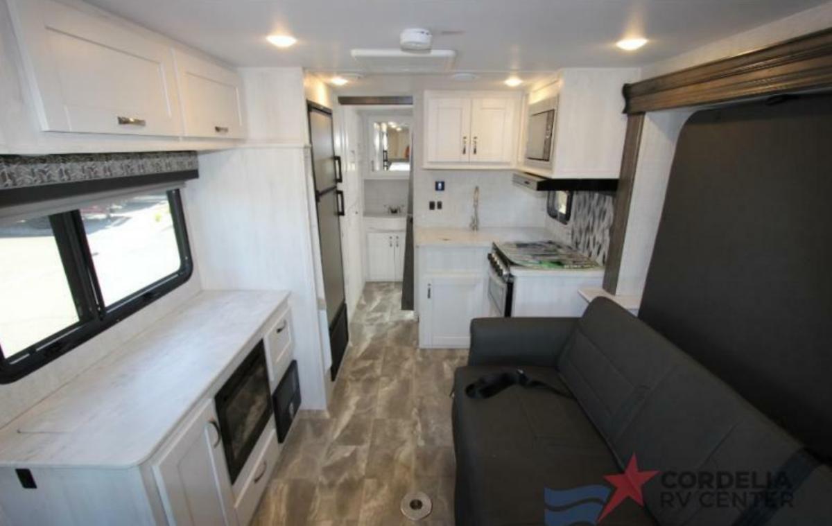 Interior view of the RV with a living space and a kitchen.