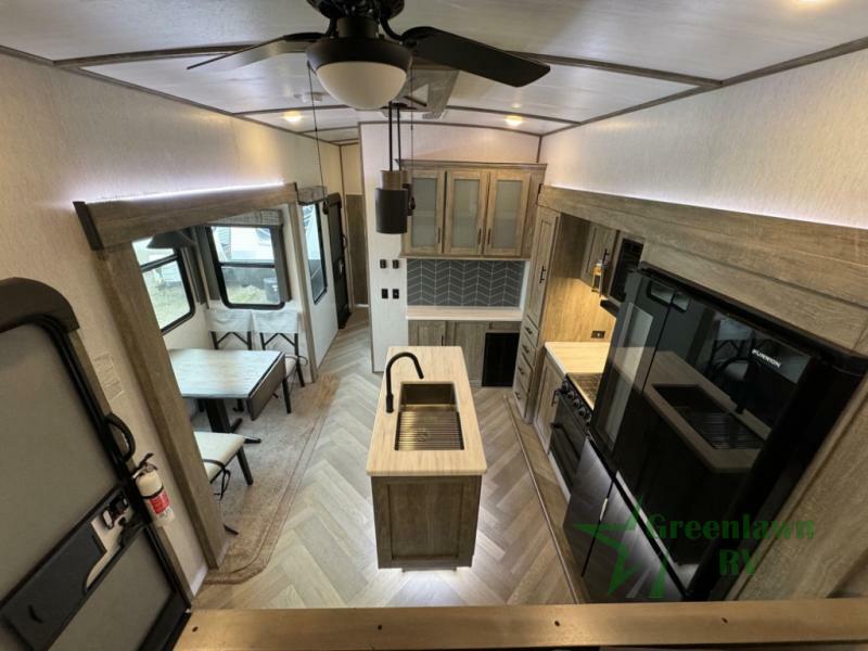 Interior view of the RV with a dinette and a kitchen.