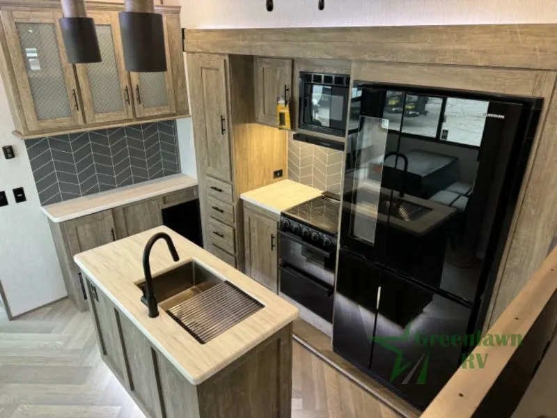 Kitchen with a gas burner, fridge, oven, sink and cabinets.