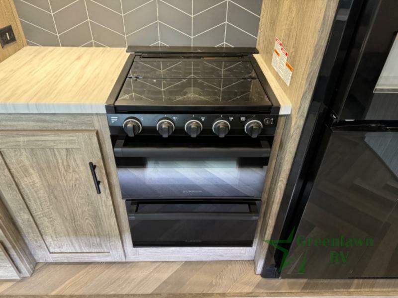 Kitchen with a gas burner and cabinets.