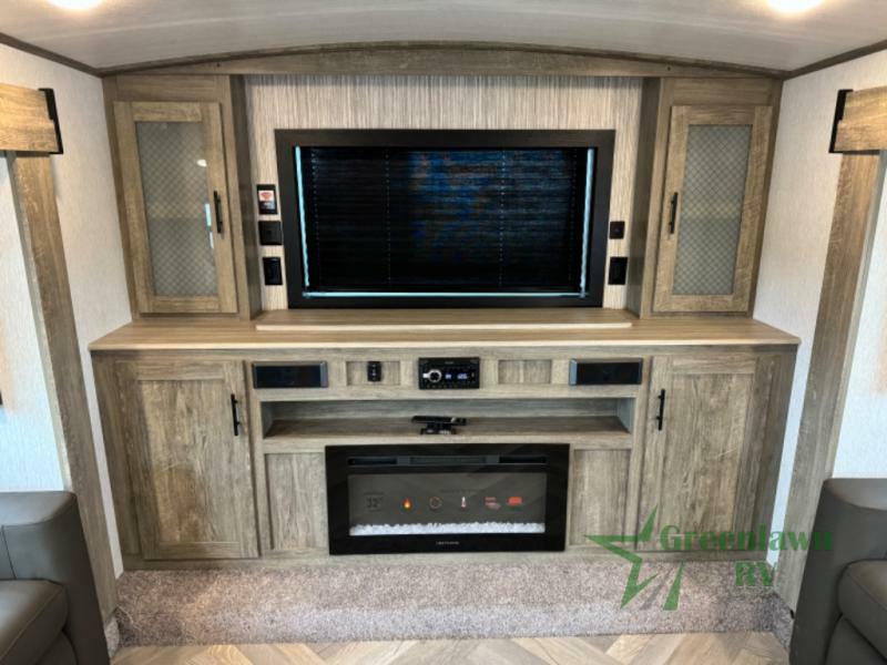 Entertainment center with a TV and a fireplace.