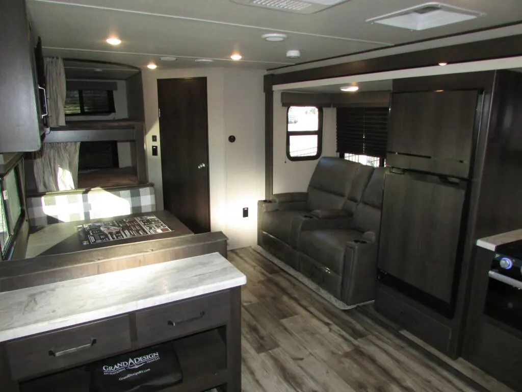 Interior view of the RV with a living space and a kitchen.