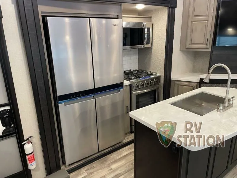 Kitchen with a gas burner, fridge, oven, sink and cabinets.