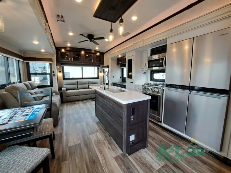 Interior view of the RV with a dinette, living space and a kitchen.